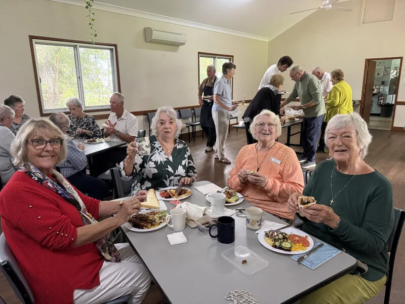 abbey-church-community-lunch Church community members seated together for a shared meal in Abbey Hall