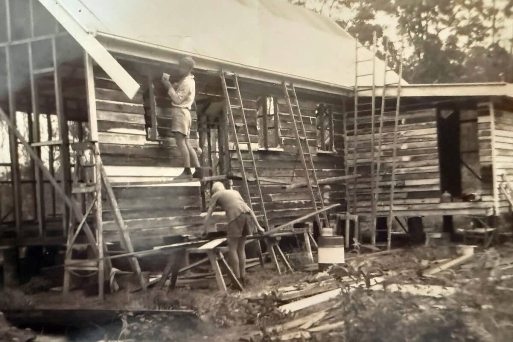 Volunteers fixing weatherboards to the frame of the original Abbey Church.