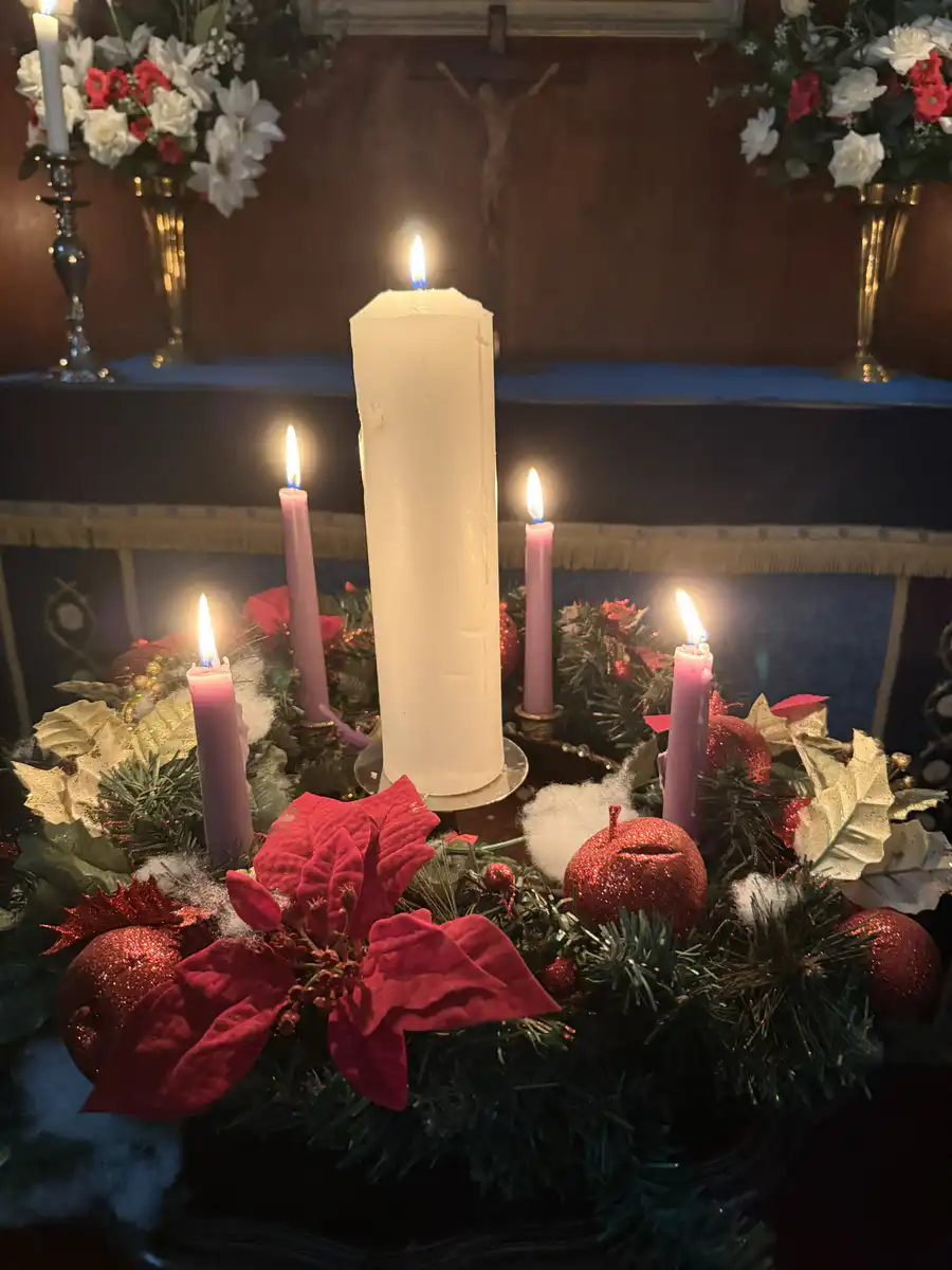 Advent Wreath at The Abbey Church Lit Advent wreath with purple and white candles inside The Abbey Church