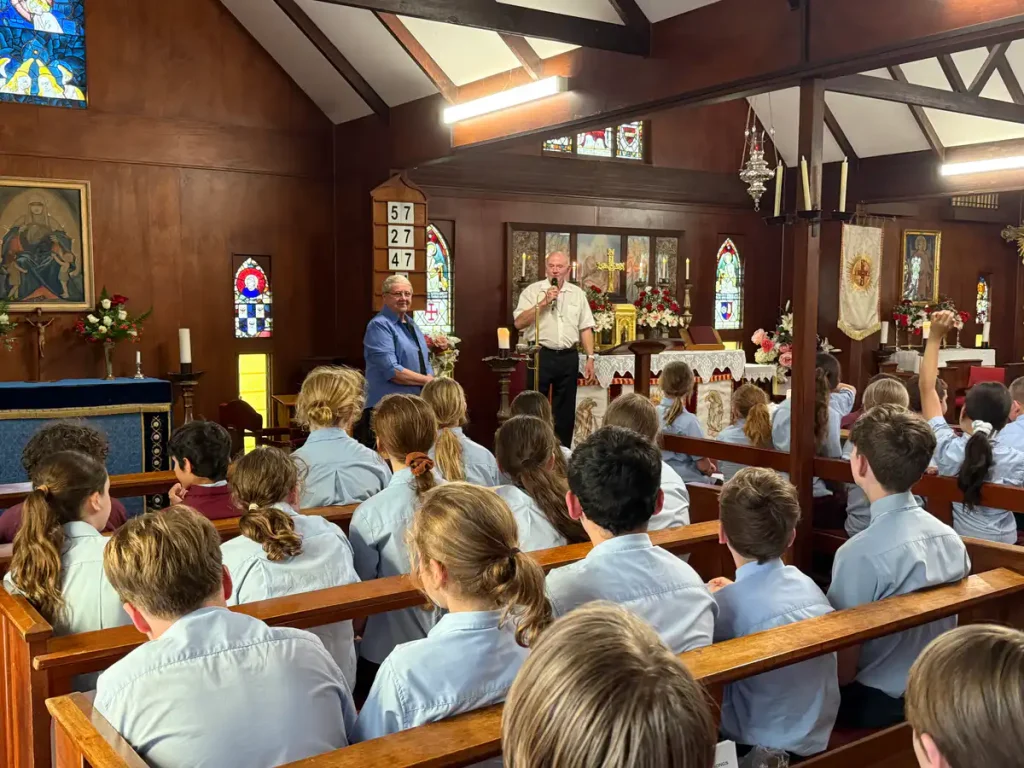 Students attending a school chapel service inside The Abbey Church