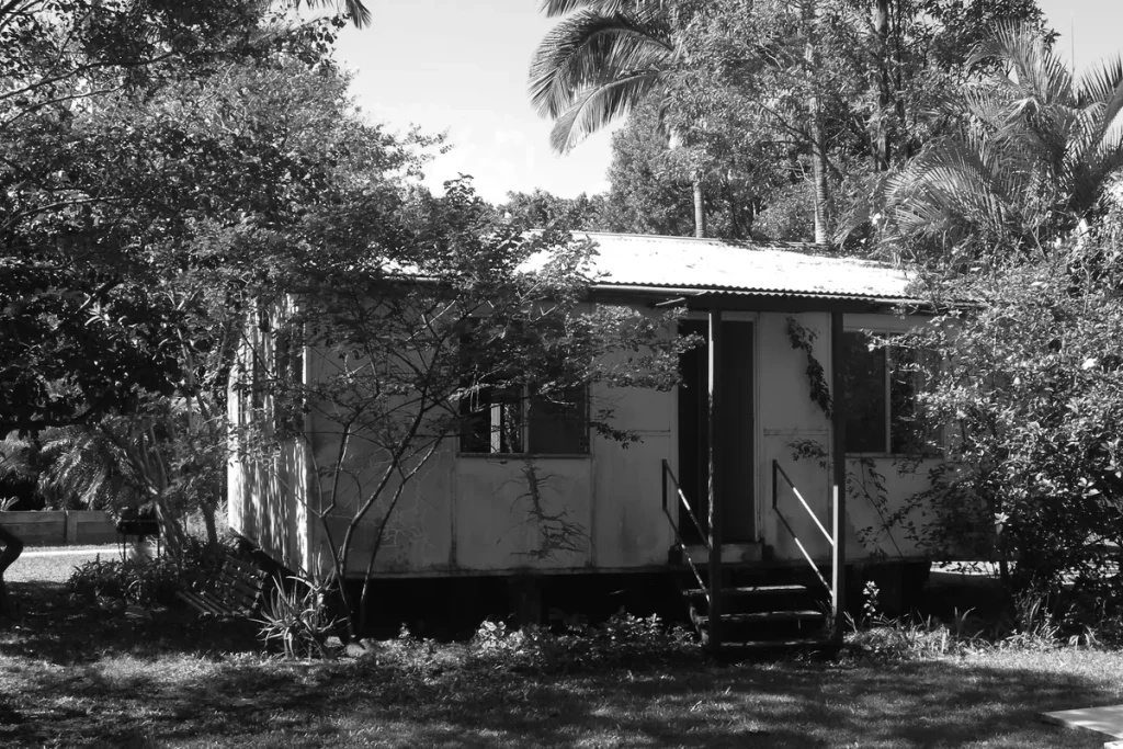 Early Abbey Community house surrounded by trees in Queensland
