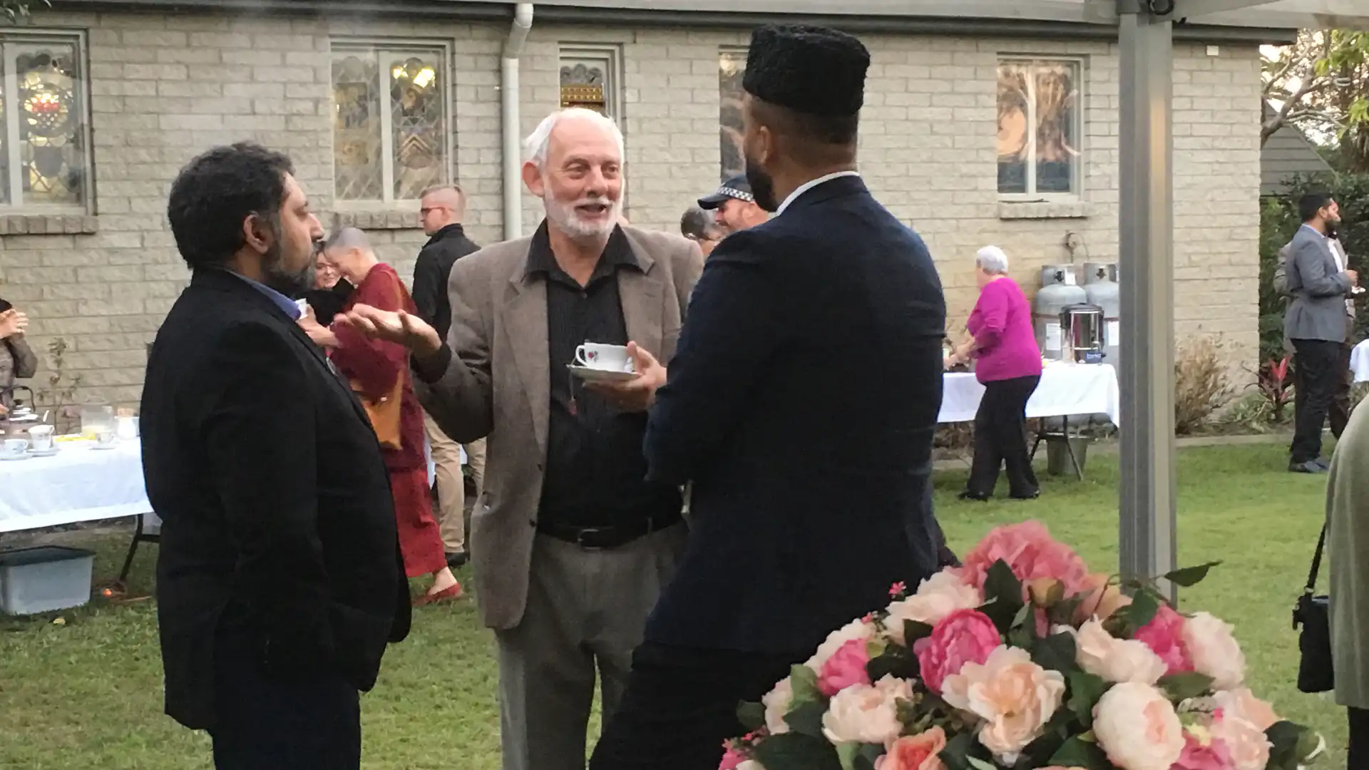 Guests of different faith traditions talking on the lawn at the Abbey Multi-Faith and Cultural Dialogue Centre launch in Caboolture