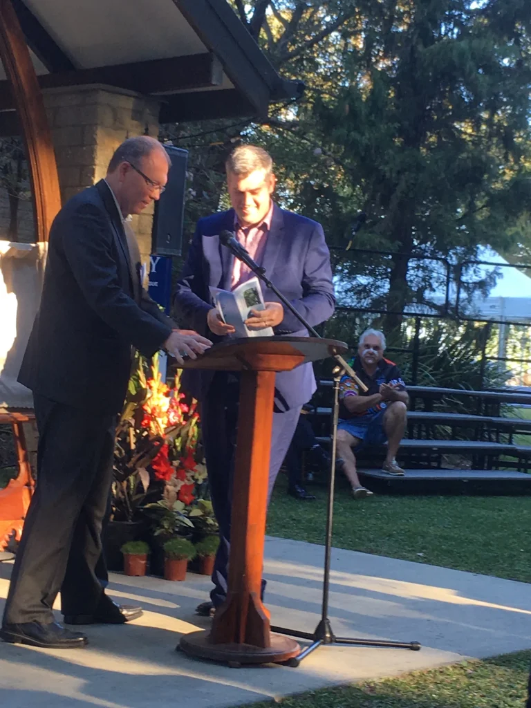 Two speakers at the lectern for the official opening of the Abbey multi faith centre in Moreton Bay, August 2018