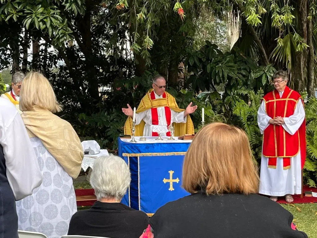 Clergy celebrating Communion outdoors at The Abbey Church