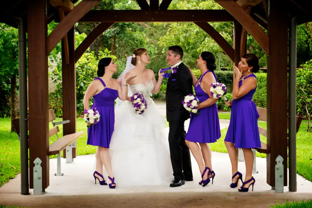 Chapel wedding party beneath a pavilion in the Abbey Church gardens
