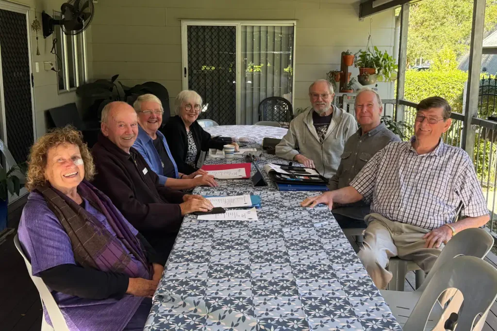 Members of the Moreton Bay Goodwill Committee around the table at one of their regular meetings