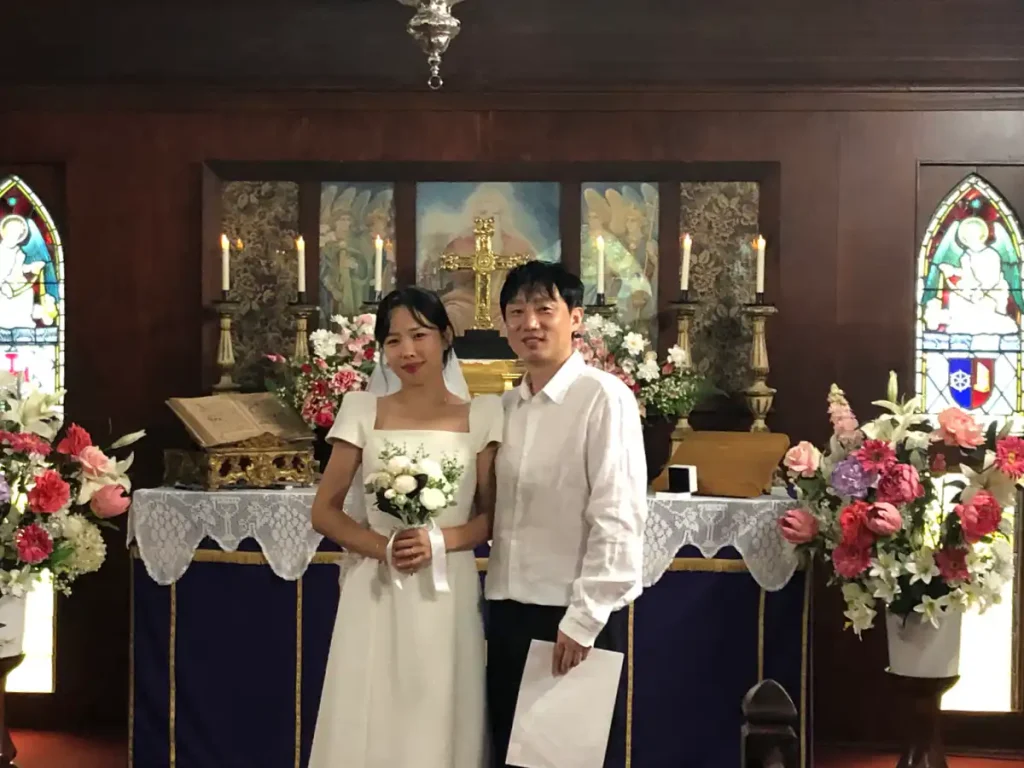 Newly married couple at the altar after a chapel wedding at The Abbey Church