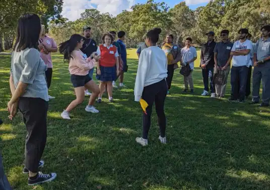 Young people taking part in an outdoor group activity on the lawn at the Youth 4 Youth Forum